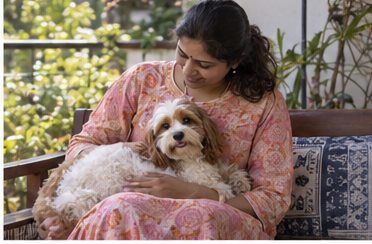 AI-generated illustration of a seated woman petting a dog on a garden veranda