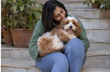 AI-generated illustration of a seated woman holding and petting a dog on outdoor steps