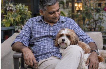 AI-generated illustration of a seated man with a brown-and-white dog in a garden seating area
