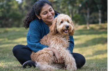 Illustration of people spending time with a Goldendoodle at home or outdoors