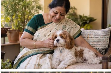 A woman in a sari sits with a small brown-and-white dog at home